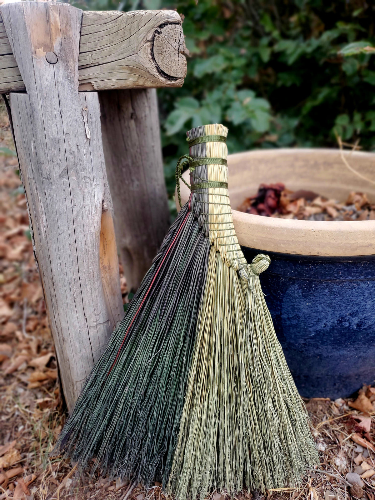 A whisk broom handcrafted and dyed using natural broomcorn and serene magical intentions  